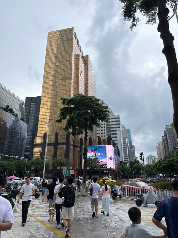 Busy morning streets in Guangzhou's Tianhe District under grey skies
