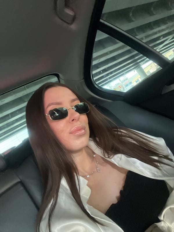 Woman in sunglasses observed in car backseat, Moscow