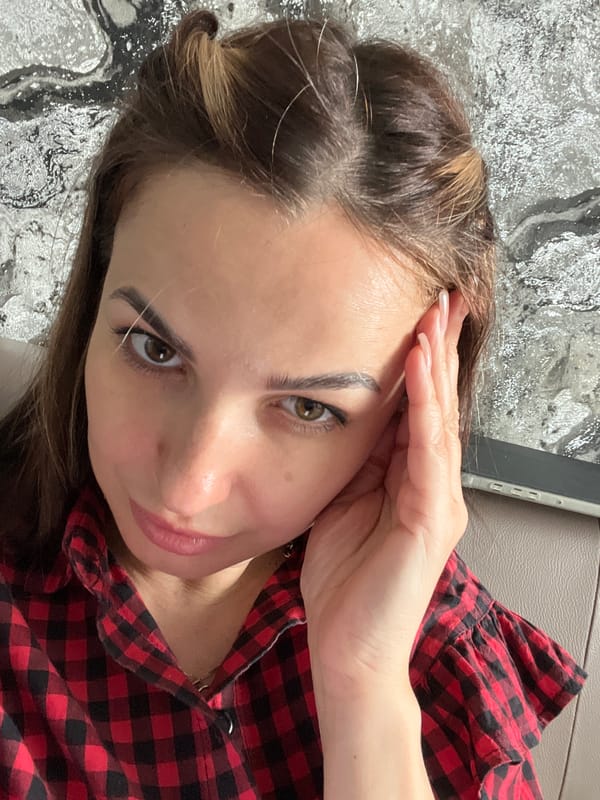 Woman in checkered shirt recorded in casual indoor moments