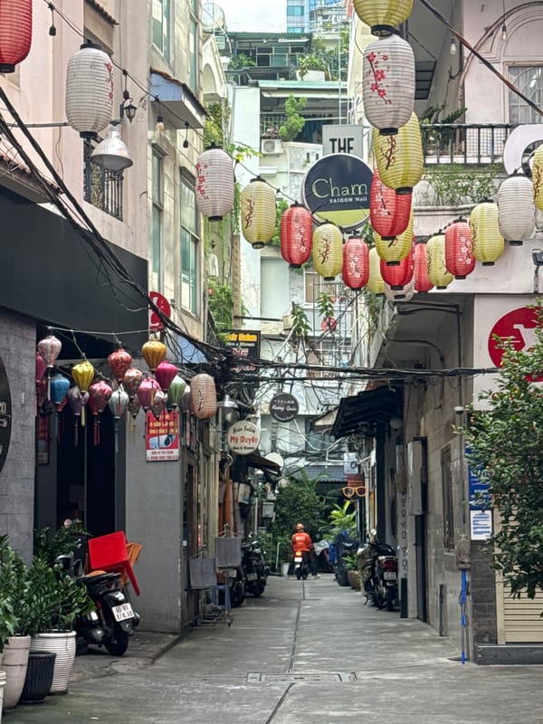 Colorful paper lanterns line a narrow Thủ Đức street
