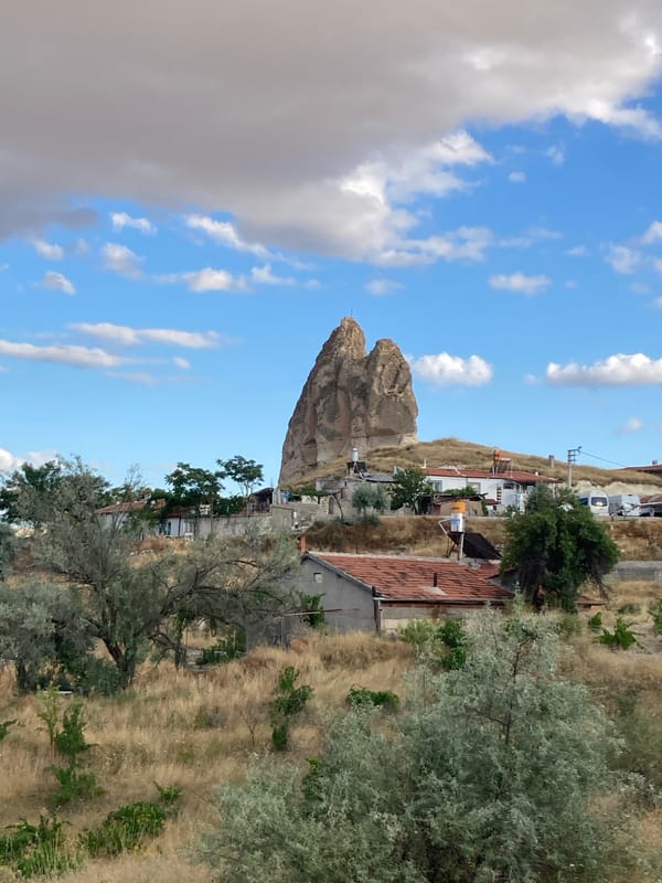 Afternoon scenes from Avanos: farmland, rocky horizons, and a curious cat