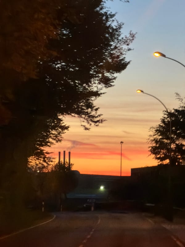 Sunset observed in Leudelange, Luxembourg with illuminated street scene
