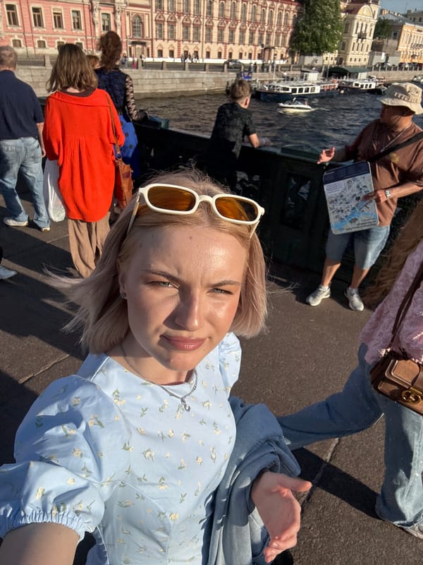 Tourists explore historic Saint Petersburg landmarks on sunny afternoon