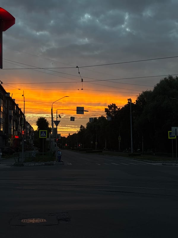 Novokuznetsk tram street glows under a vivid summer sunset