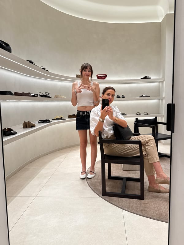 Women take mirror selfie at Loures retail store
