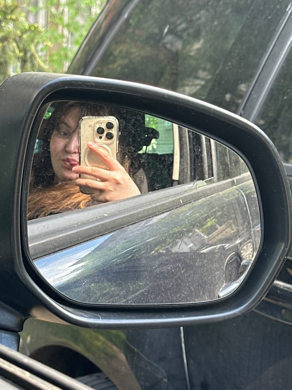 Person takes creative selfie using car mirror in Bulgaria