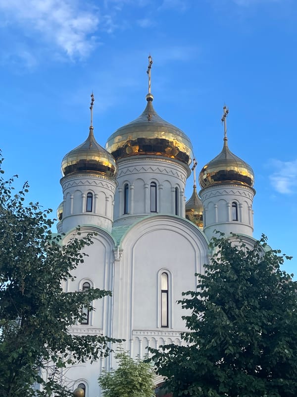 Afternoon stroll past Moscow church and residential high-rises