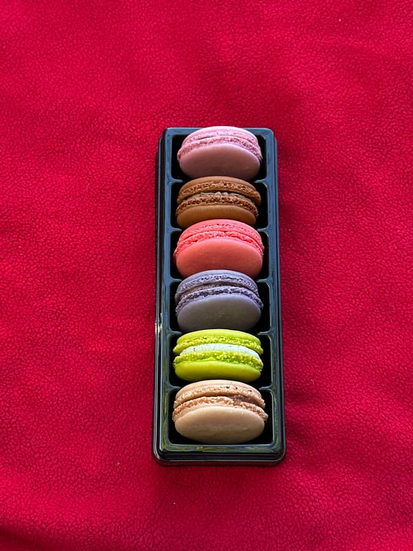 Colorful macarons displayed on blanket in Port Moody