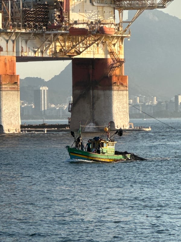 Fishing boats, an oil rig, and an egret on Guanabara Bay