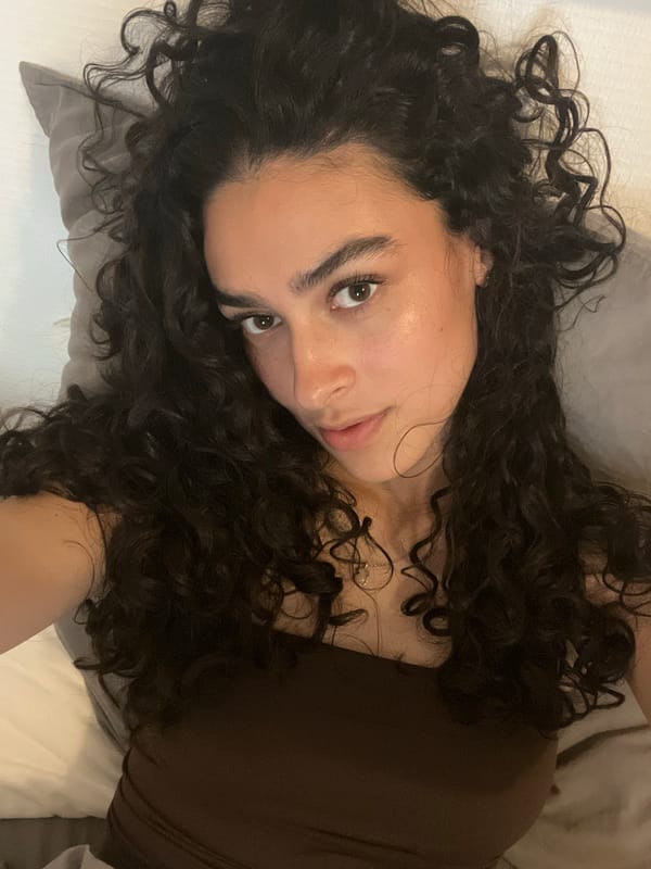 Woman resting on pillow observed in Lyon bedroom