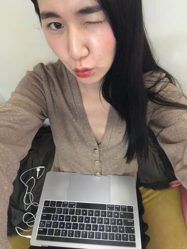 Person with laptop rests on cushioned surface in Paris