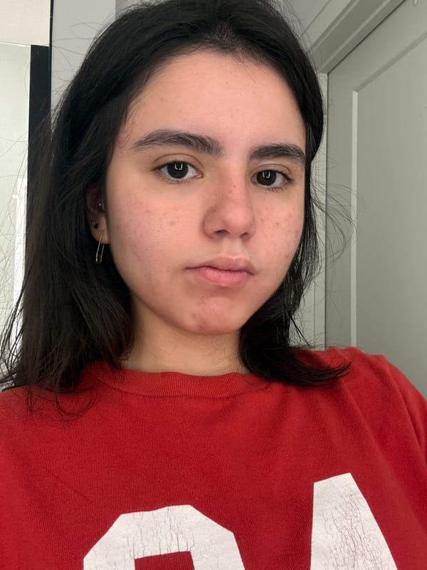 Woman in red shirt photographed indoors in Austin