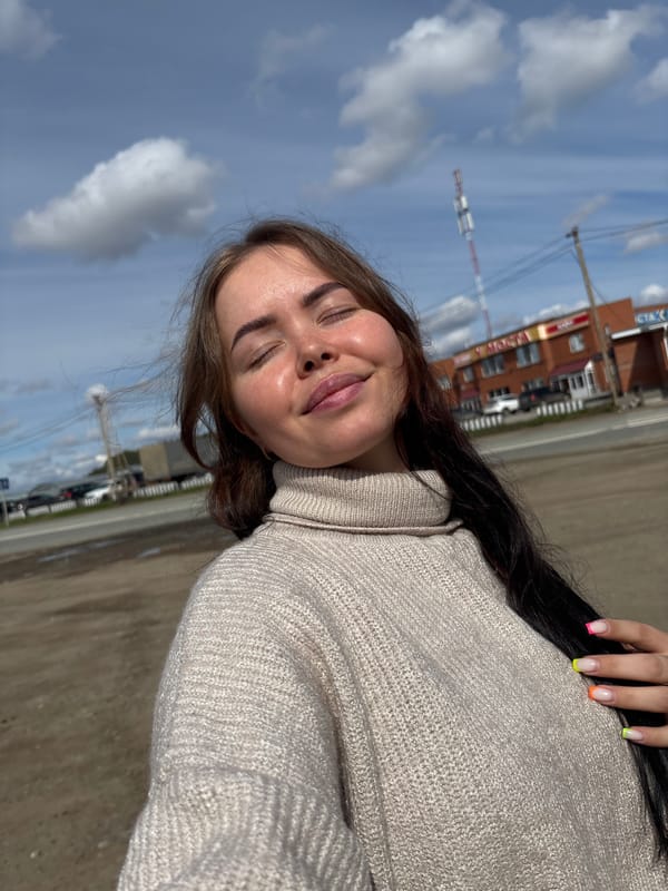 Woman poses for photos on car in rural Russia
