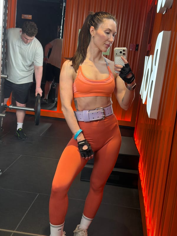 Woman takes gym selfies in orange workout gear, Perm