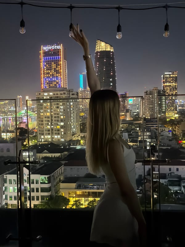 Rooftop moment overlooking Đà Nẵng city skyline at night
