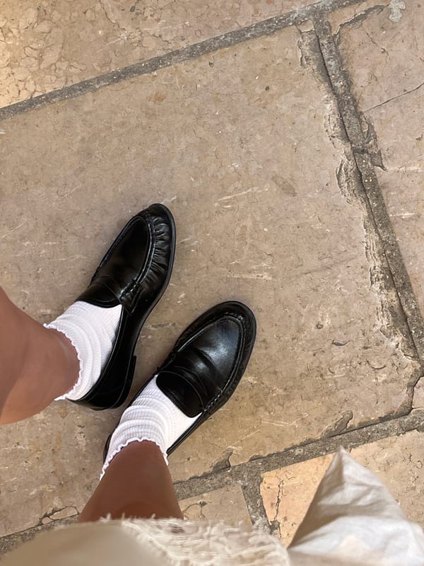 Person in distinctive footwear spotted near antique clock in Lyon