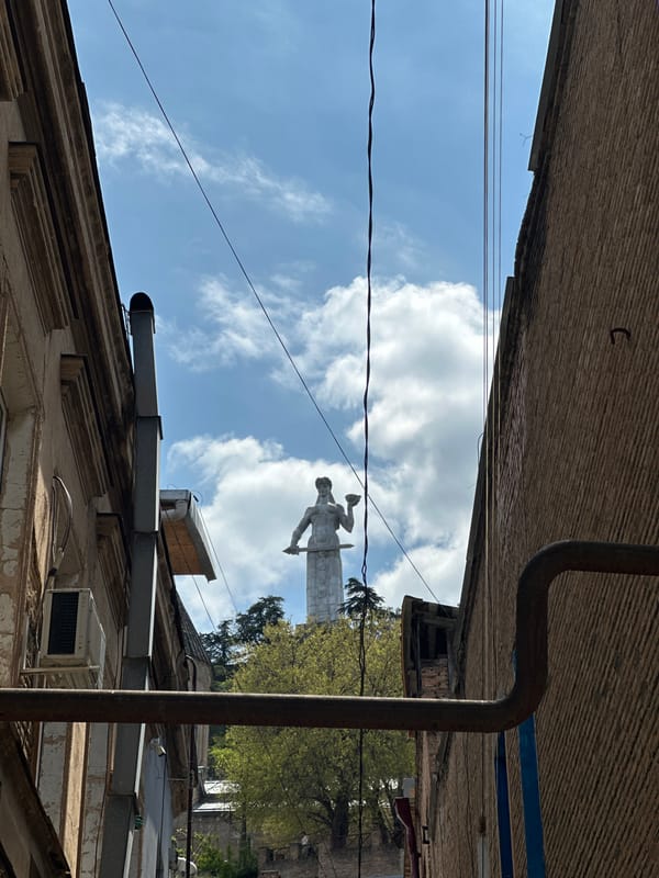 Tourist documents morning walk through historic Tbilisi streets