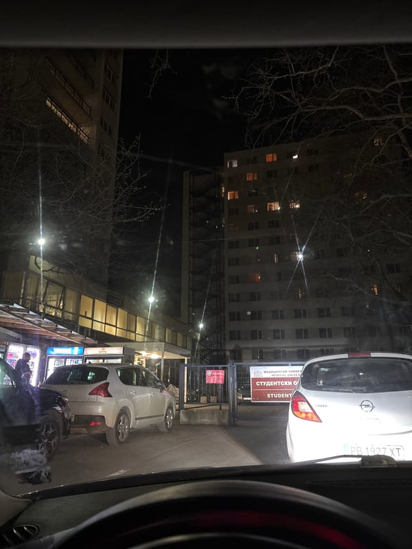 Two white cars parked on Plovdiv street at night