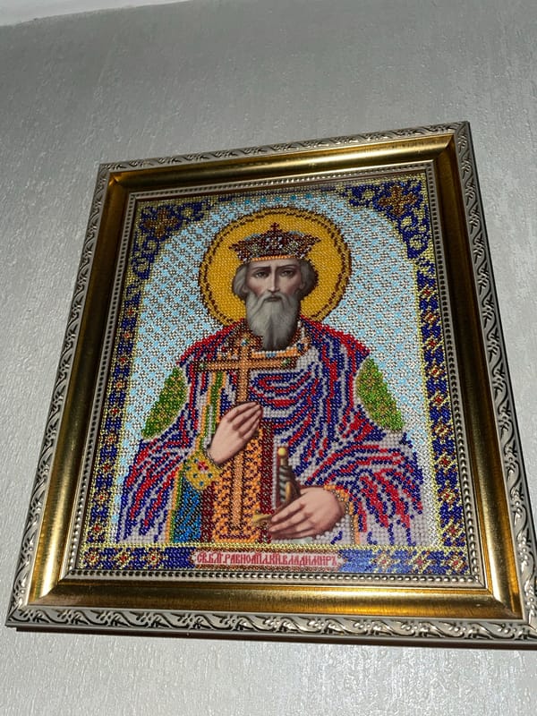 Religious icons and handmade crafts displayed in Brest interior
