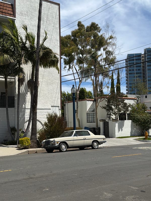 Vintage white Mercedes parked on a Long Beach residential street