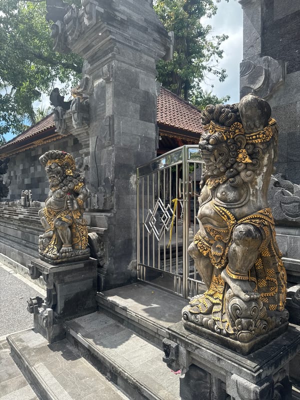 Tourist documents Balinese temple statues and coastal views in Nusa Penida