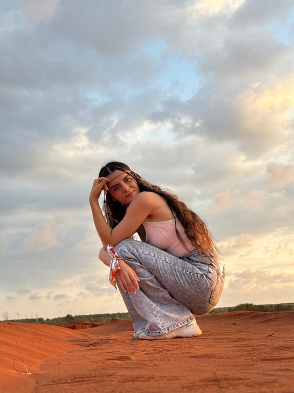 Tourist photographed at Mũi Né sand dunes during golden hour