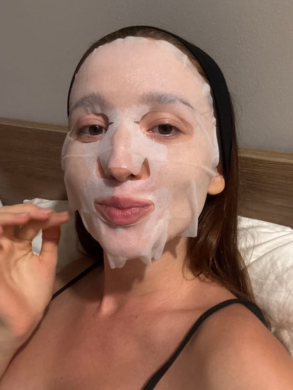 Woman documents skincare routine with sheet mask in Thailand
