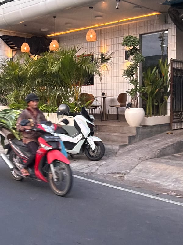 Street traffic rolls through Mengwi on an overcast morning