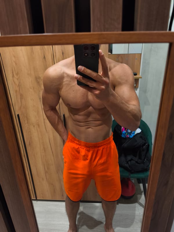 Shirtless man takes mirror selfie in Moscow bedroom