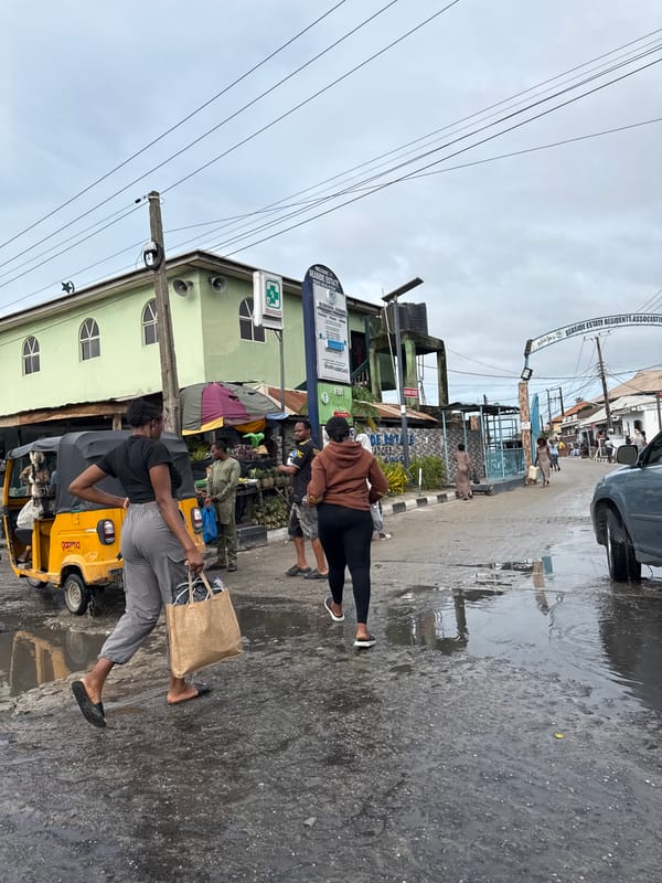 Pedestrians walk wet streets in Ado after rain