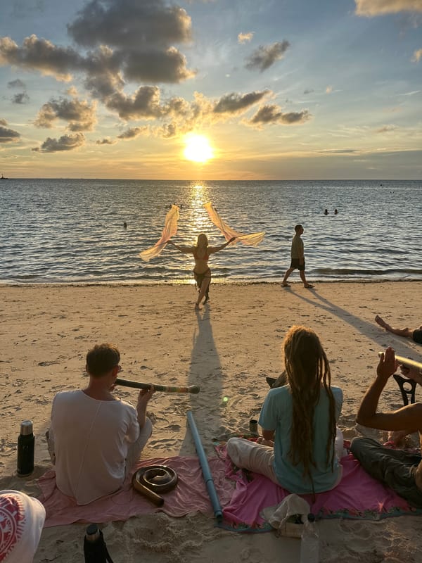 Beachside sunset session with flags, music, and water on Koh Phangan