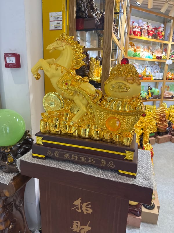 Golden horse statue displayed indoors in Yuexiu District