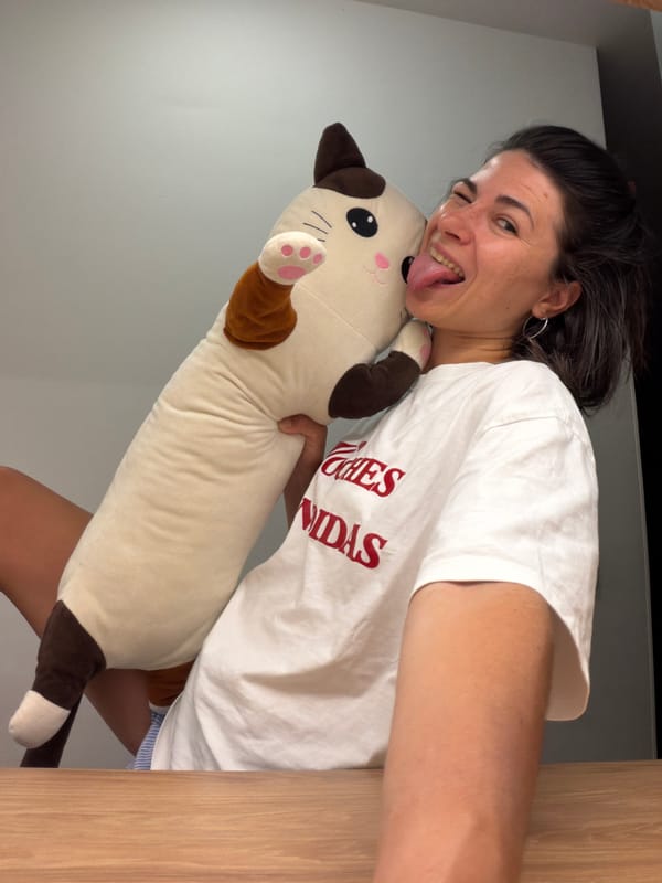 Woman poses with plush cat toy in Budva apartment