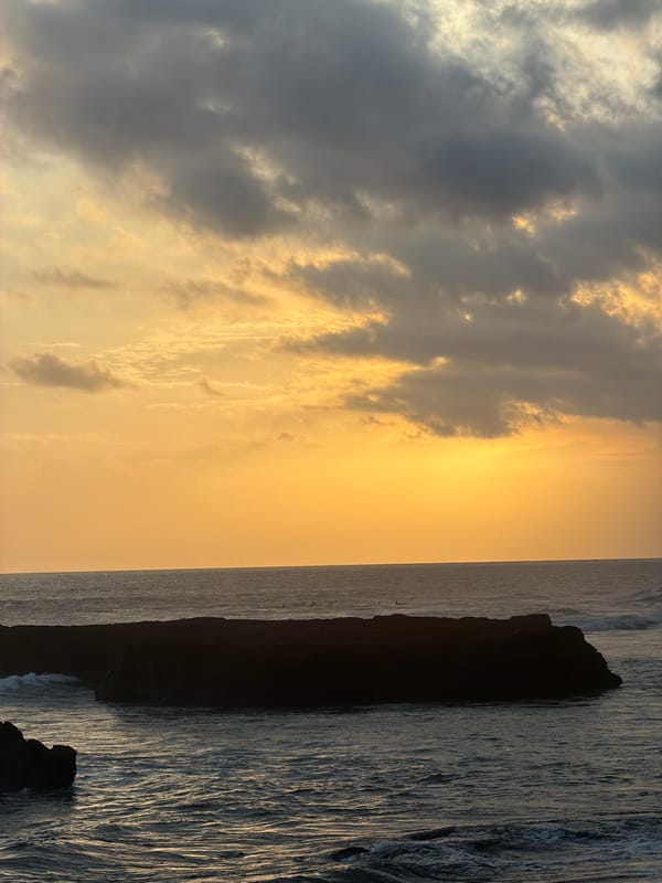 Sunset with orange-gold clouds observed in North Kuta, Indonesia