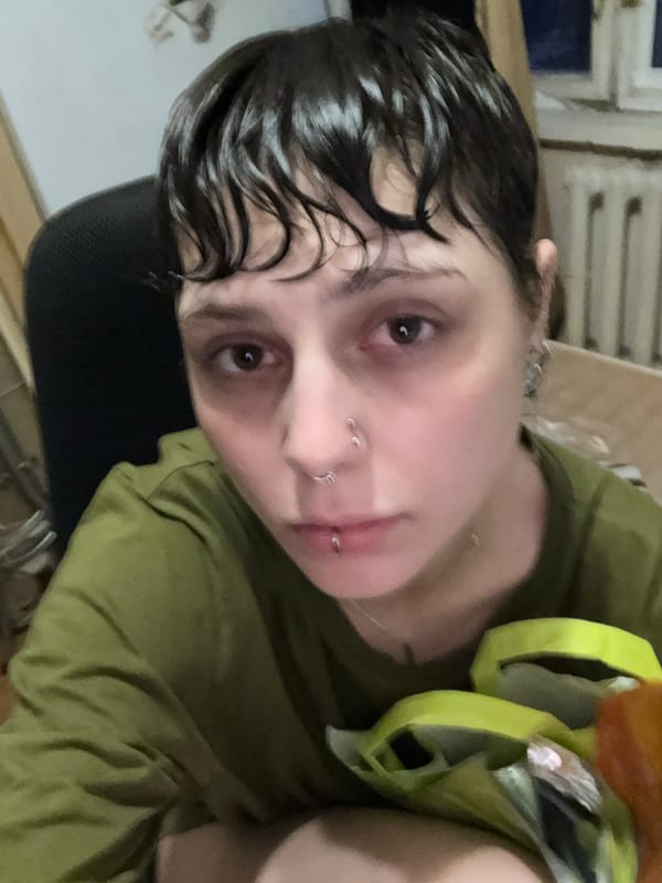 Person with piercings takes selfie in Moscow