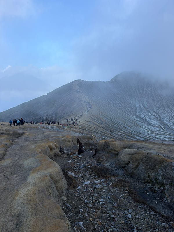 Tourists and sulfur vendors at Kawah Ijen crater, East Java
