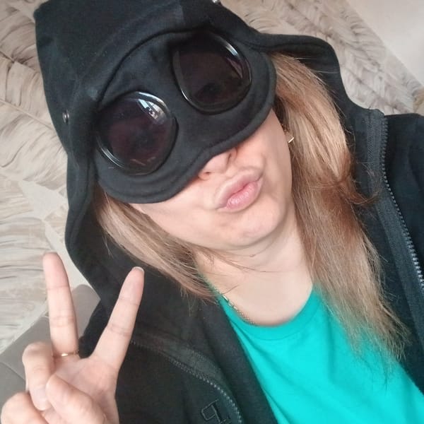 Hooded figure and black cat photographed in Izhevsk apartments