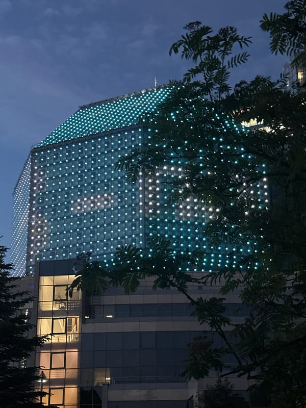 Illuminated modern building observed at dusk in Minsk