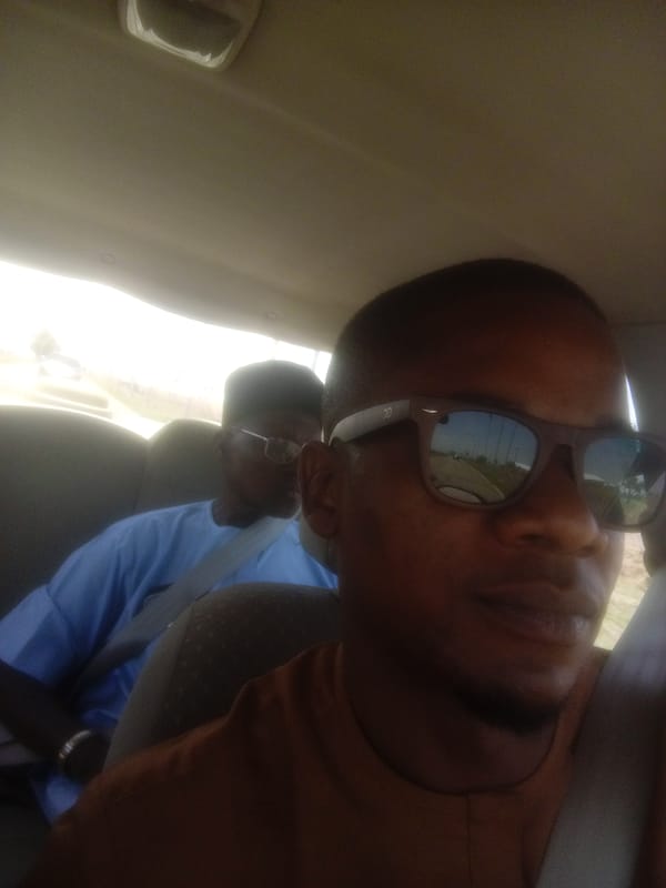 Two men traveling by car in Haifam, Nigeria