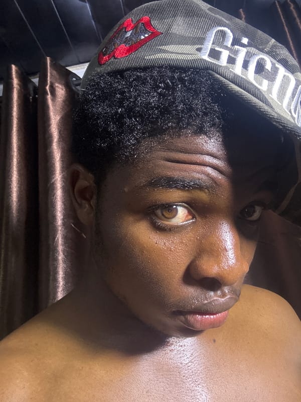Person photographed resting with camouflage cap in Bukuru, Nigeria