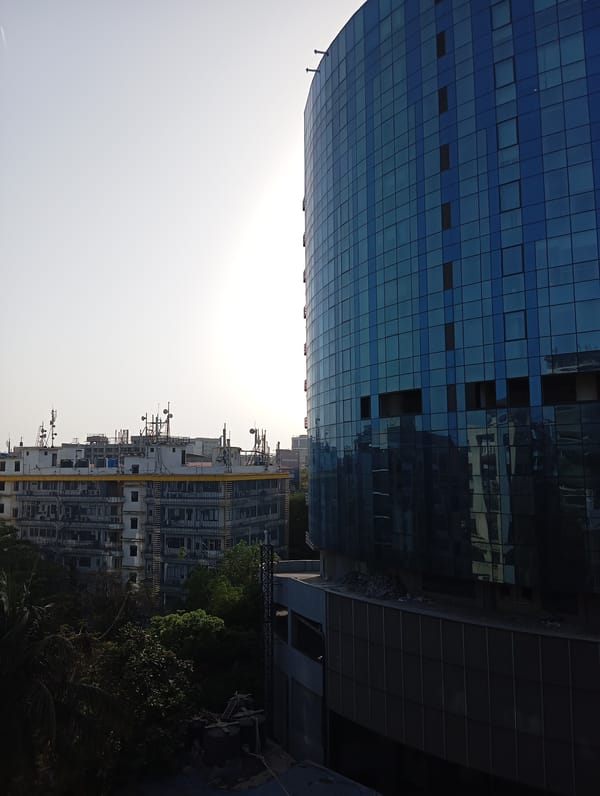 Modern glass building photographed in Mumbai urban landscape