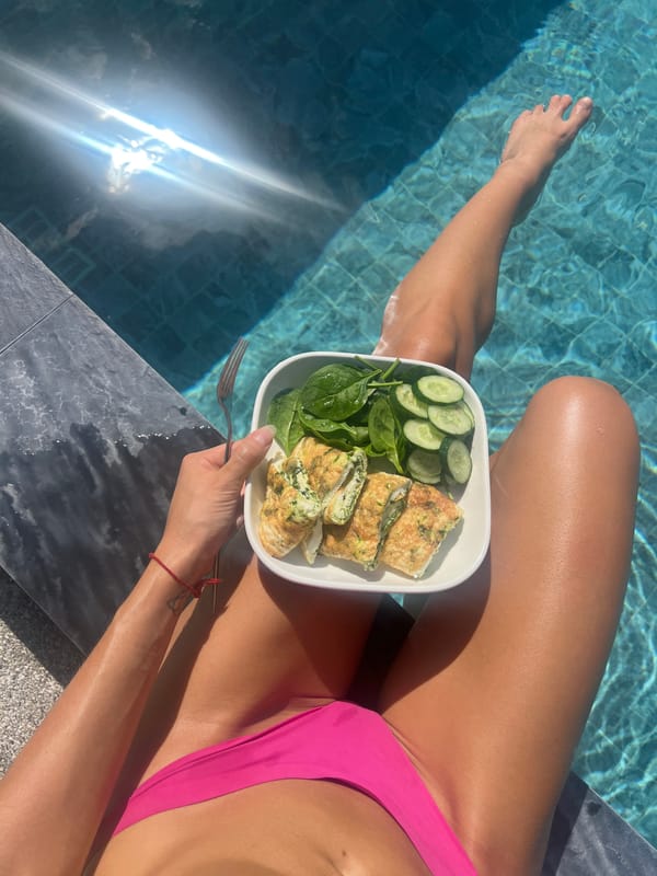 Poolside breakfast in Baan Bang Rak, legs in the water