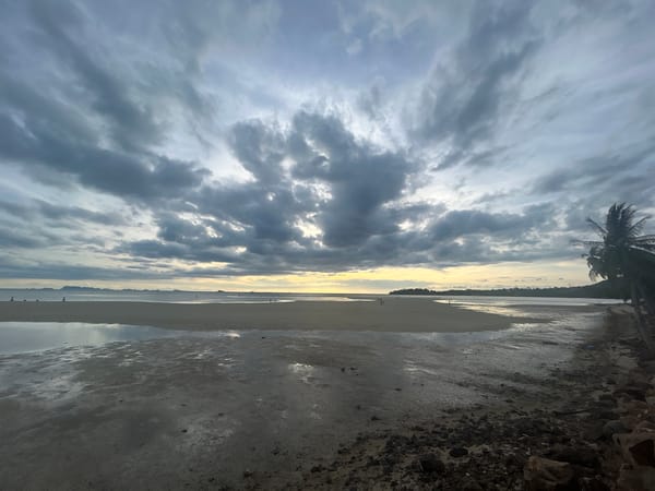 Evening beachgoers enjoy dramatic low tide at Koh Phangan