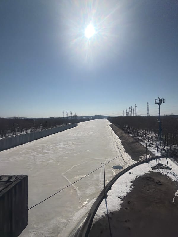 Industrial landscape documented in Chaikovsky, Russia including frozen reservoir