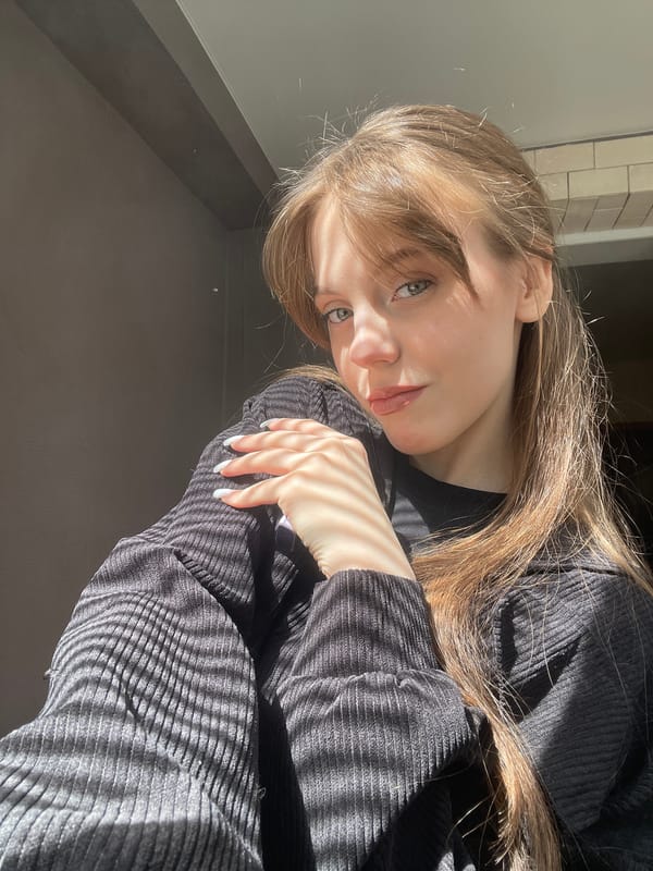 Woman in black clothing observed in indoor setting