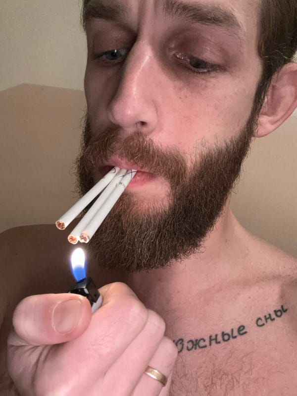 Bearded man photographed smoking, holding cat in Saint Petersburg apartment
