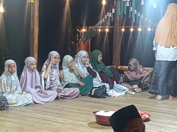 Community gathering features outdoor cooking, socializing in Kilometer Delapan