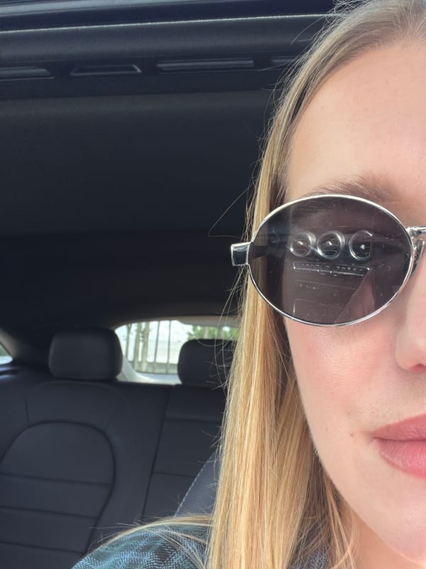 Sunglasses selfie inside a parked car in Riga
