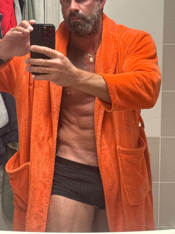 Man Takes Mirror Selfie in Orange Robe in Belgian Town