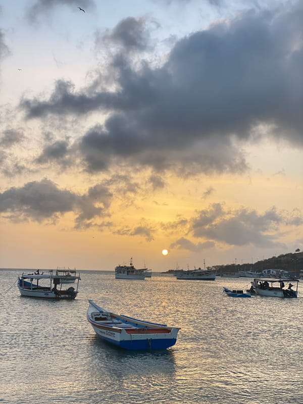 Sunset observed over Juan Griego waters with boats, storm clouds